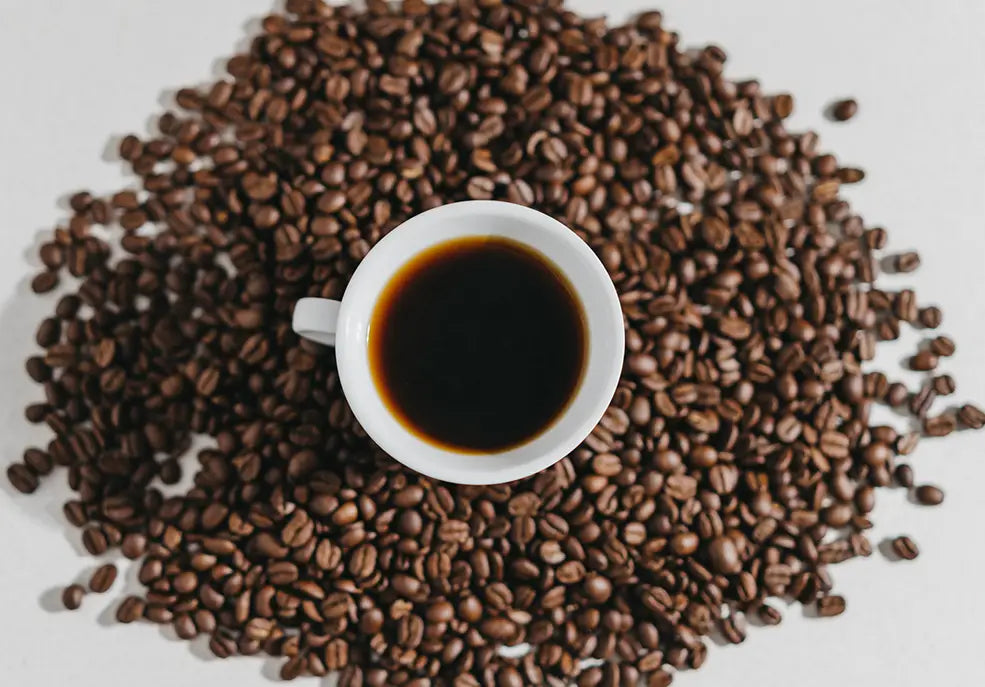 Una taza de café al rededor de granos de café
